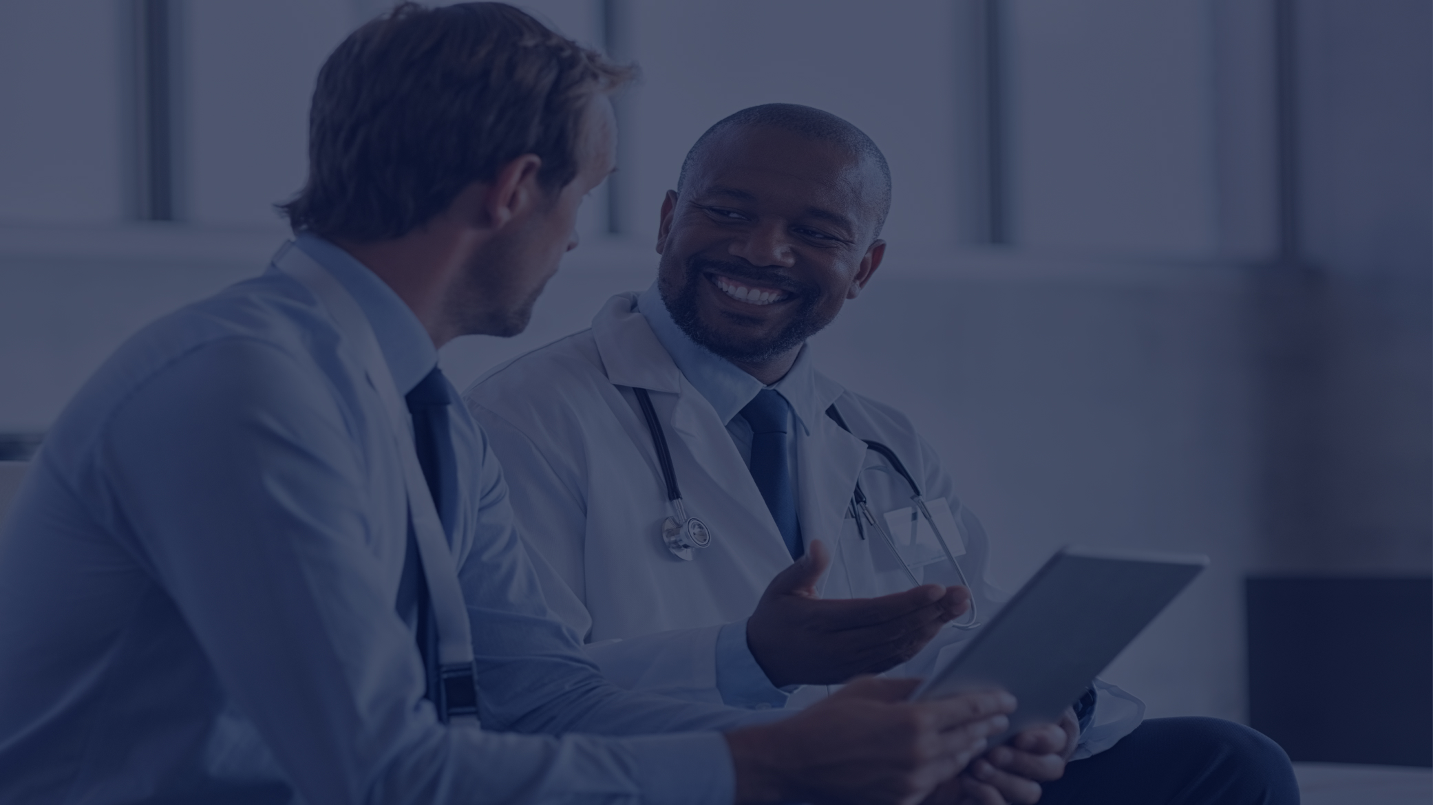 two doctors talking and smiling
