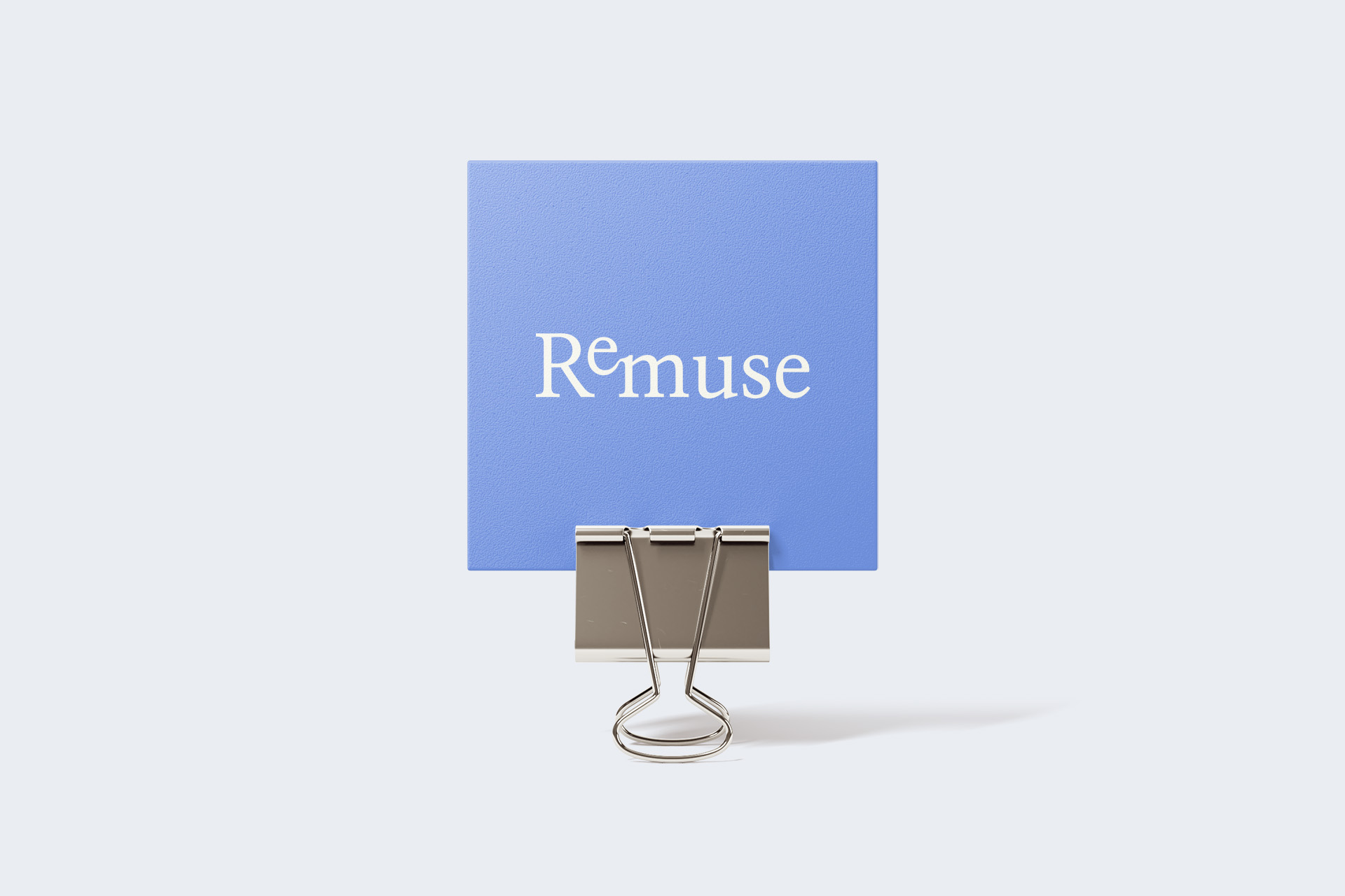 ReMuse logo printed on a purple square with a clip.