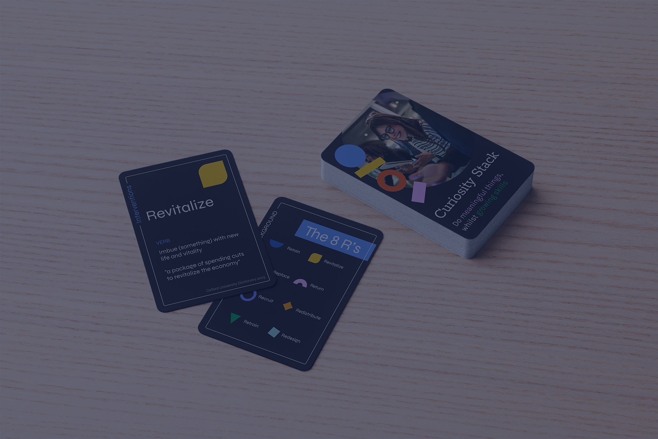 a stack of dark Curiosity Stack cards on a wooden table