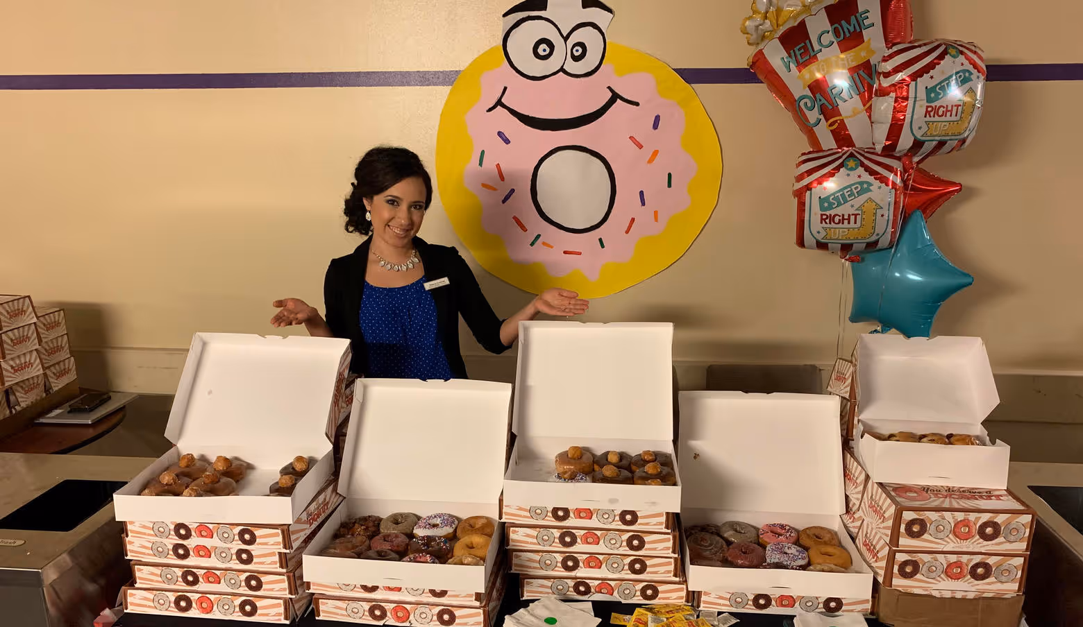 team member with countless boxes of donuts