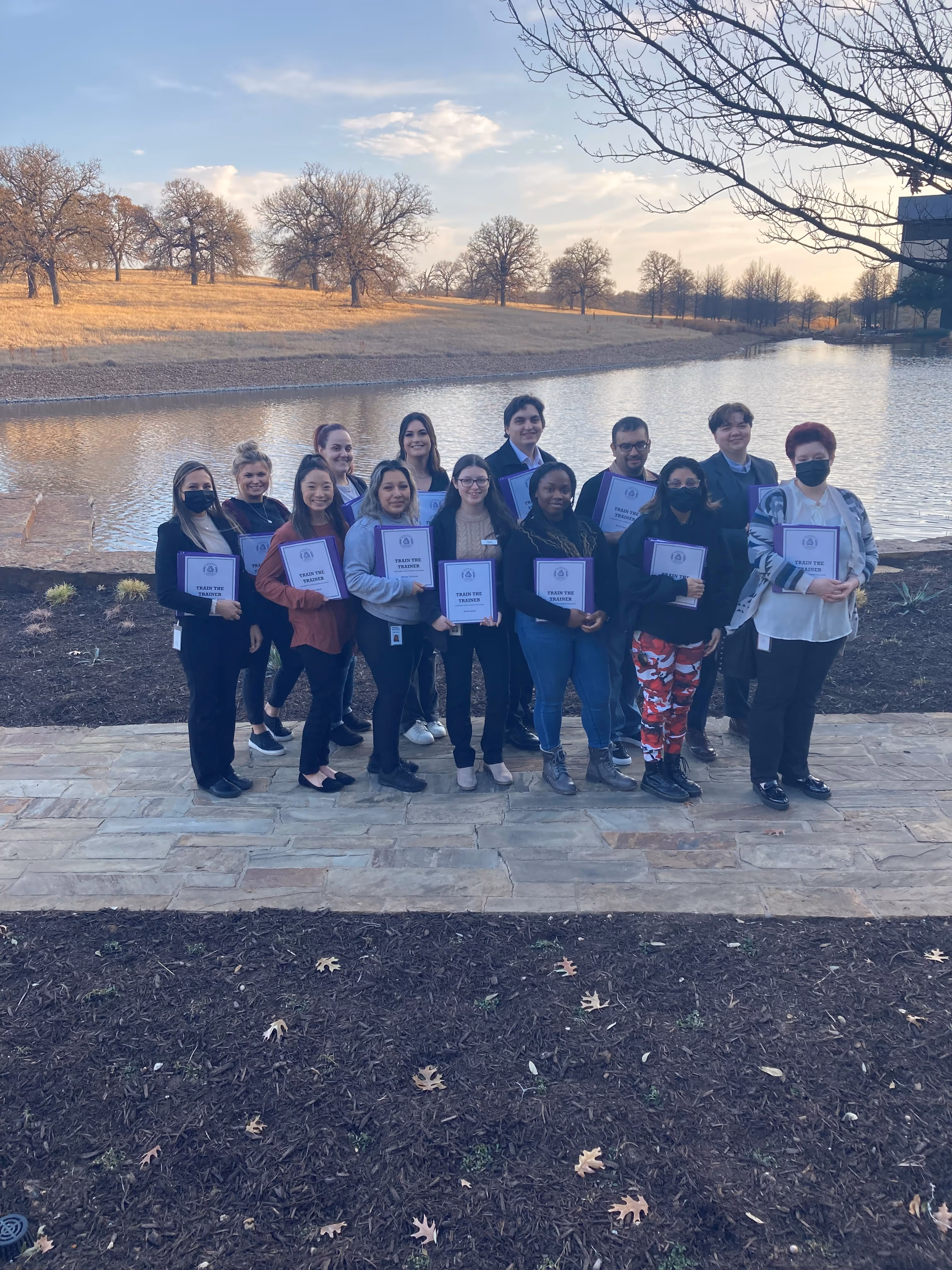 A group of students are holding the certificates