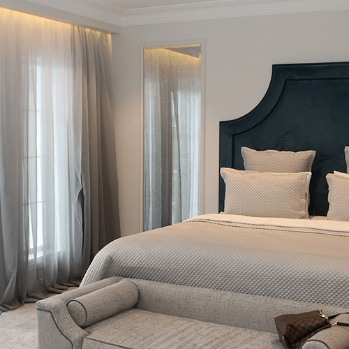 Sheer and block-out curtains in a bedroom
