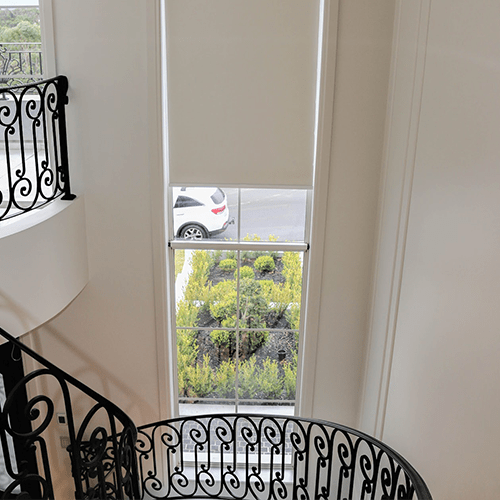 Roller blind above a curved staircase