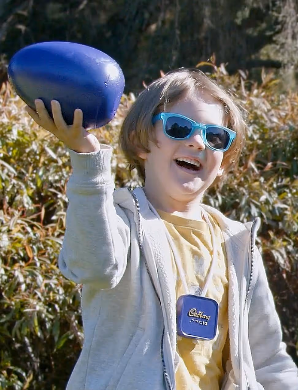 A child holding a giant Cadbury Easter egg.