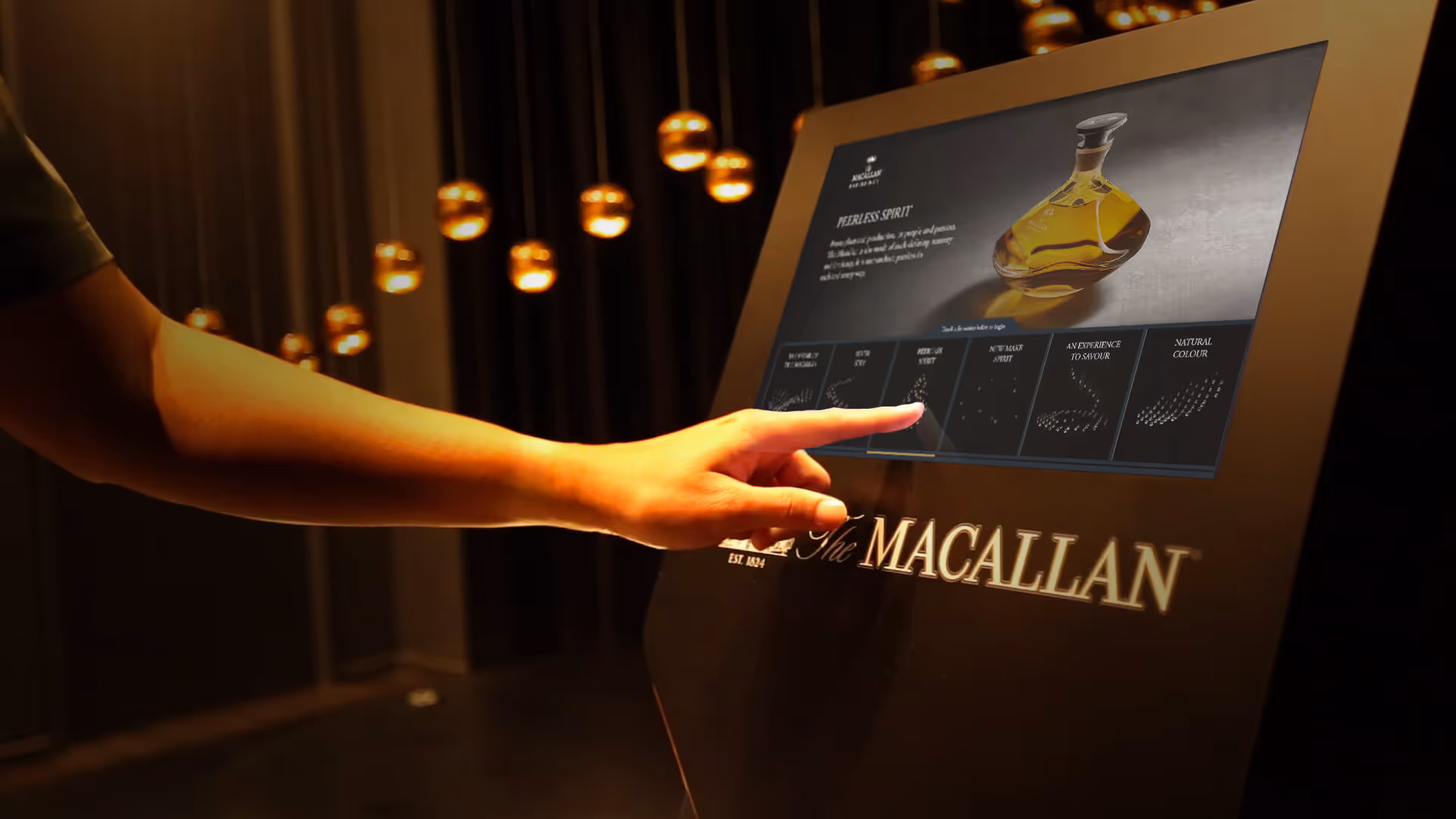 A hand touching an interactive screen at an art exhibition.