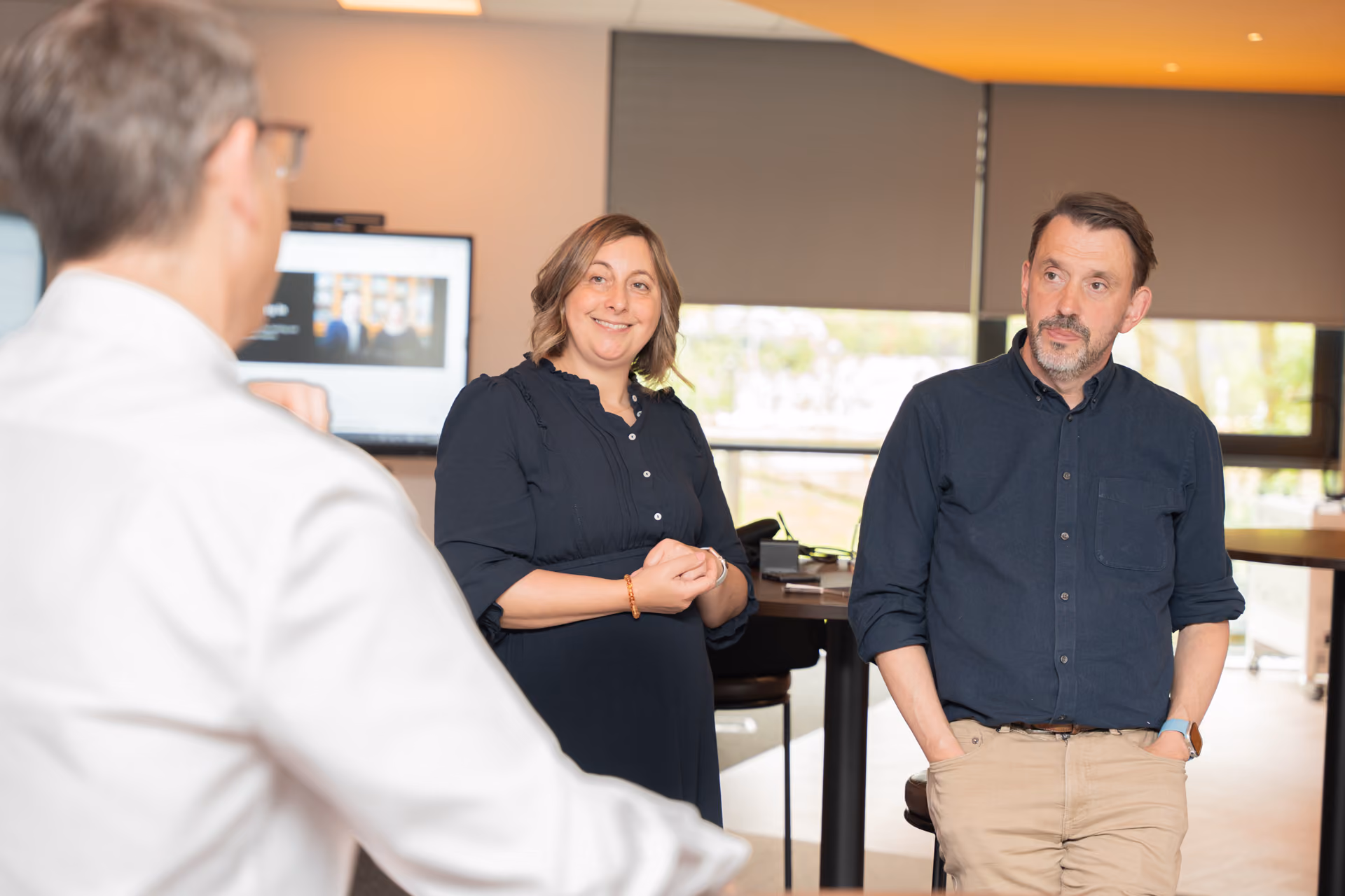 Three people discussing classroom technology in the experience centre.