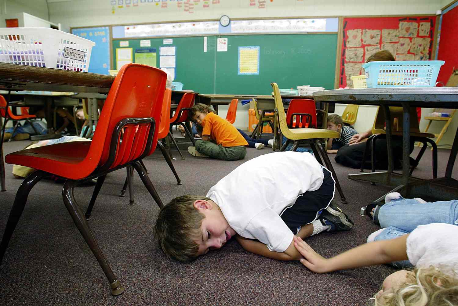 Children hiding during a school lockdown.