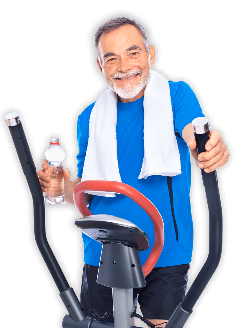 An older man working out on an elliptical.