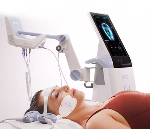 Patient undergoing Emface non-invasive facial treatment with advanced skin therapy machine