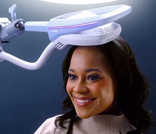 Smiling woman with Exomind non-invasive brain stimulation device to strengthen the mind and support cognitive wellness