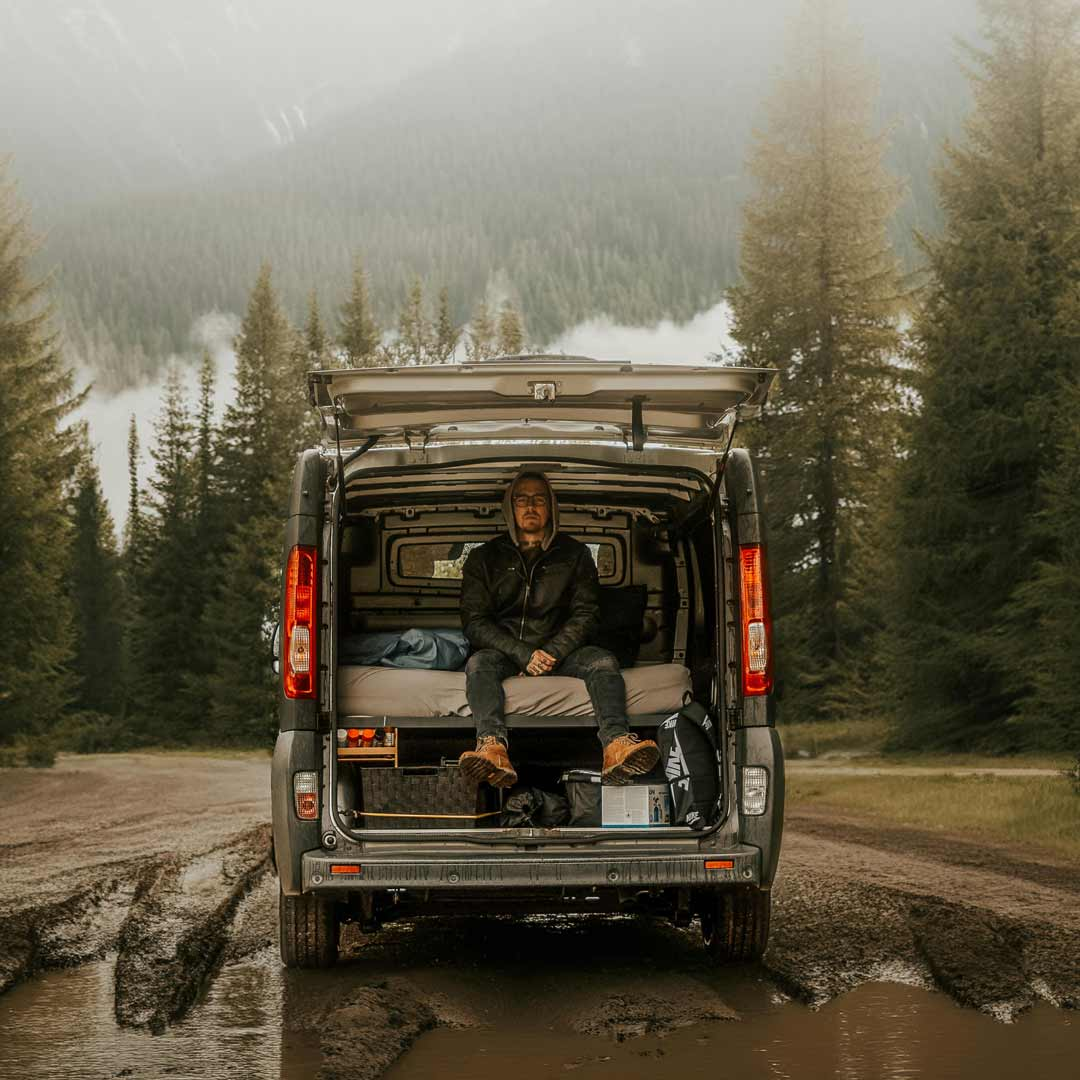 Single guy boondocking in the back of his camper van.
