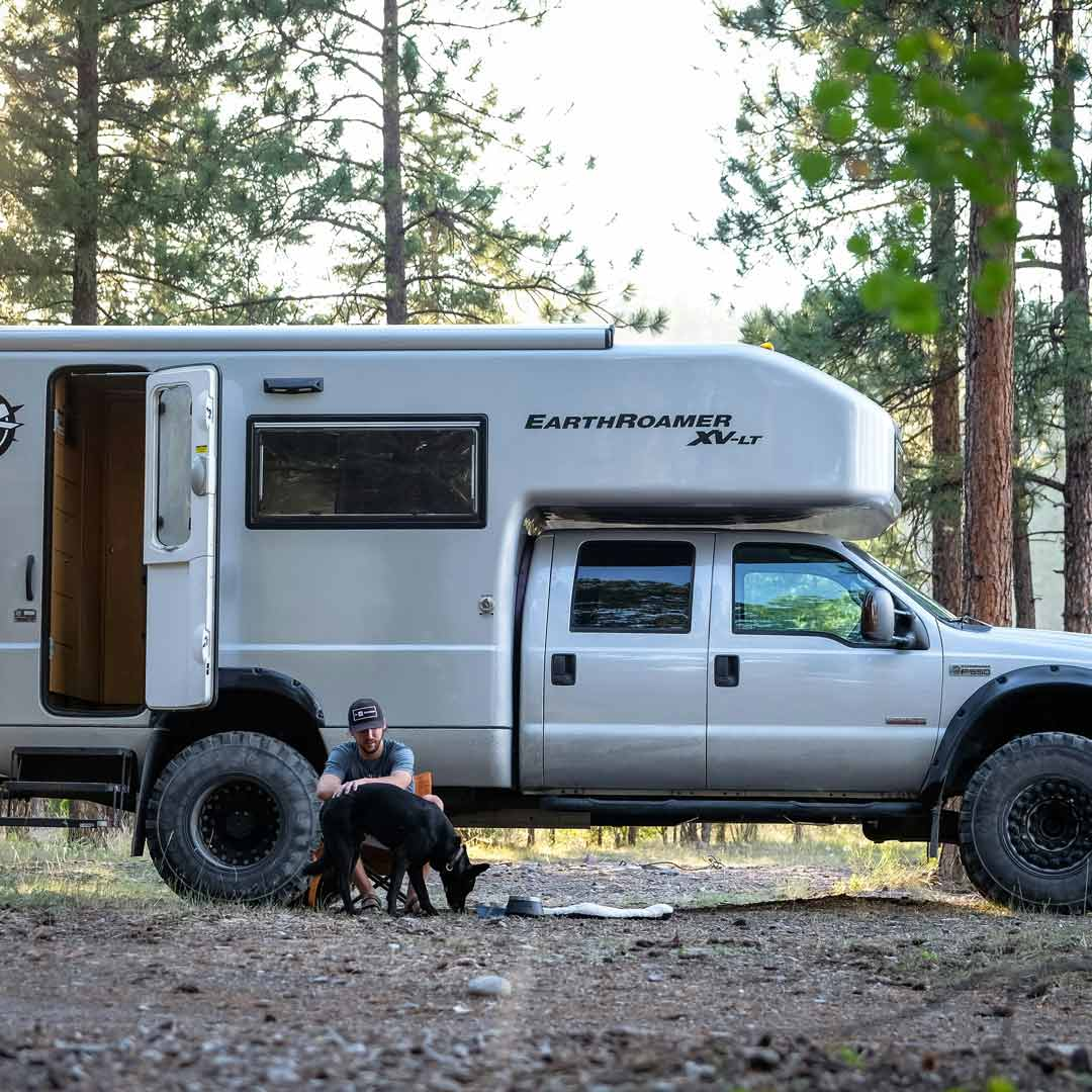 Camper with dog in front of their EarthRoamer RV