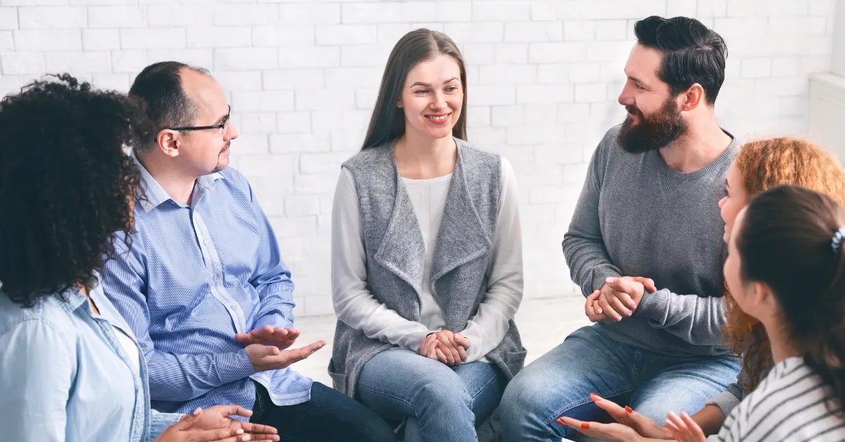 People sitting in a support circle during inpatient treatment, discussing recovery options at an inpatient program near me.
