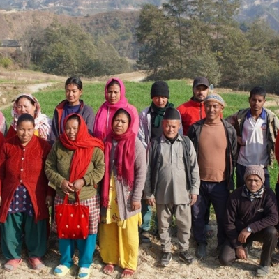 A group of Farmers of Jhamkeshwori Krishak Samuha are standing outside together sharing a message of elieve in collective action for agricultural information
