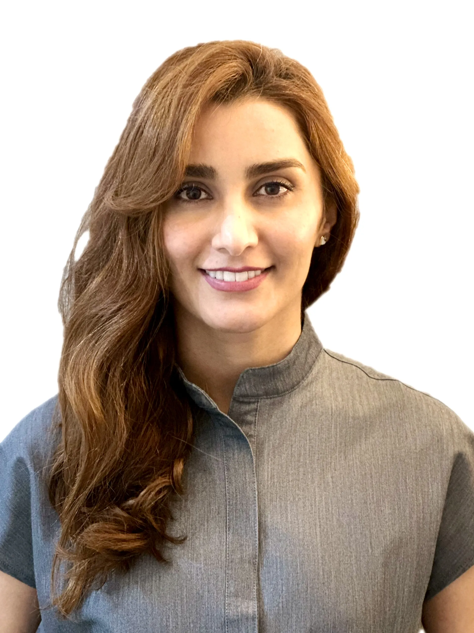 Portrait of a smiling woman with long wavy brown hair wearing a gray shirt with a mandarin collar against a white background.