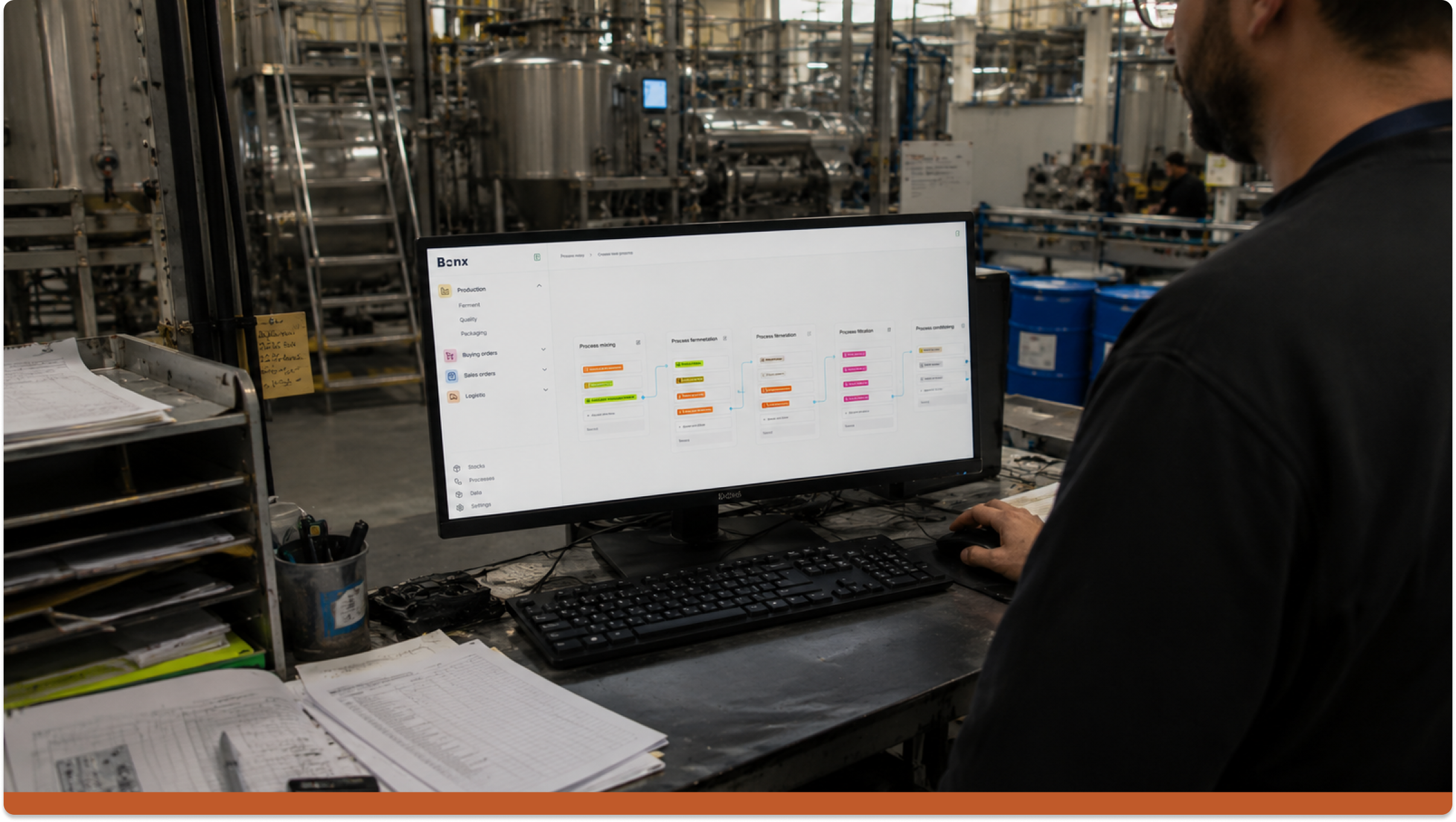 Factory operator using AI-powered manufacturing software on a production floor, illustrating practical AI in manufacturing and industrial AI applications for planning, production, and operations management.