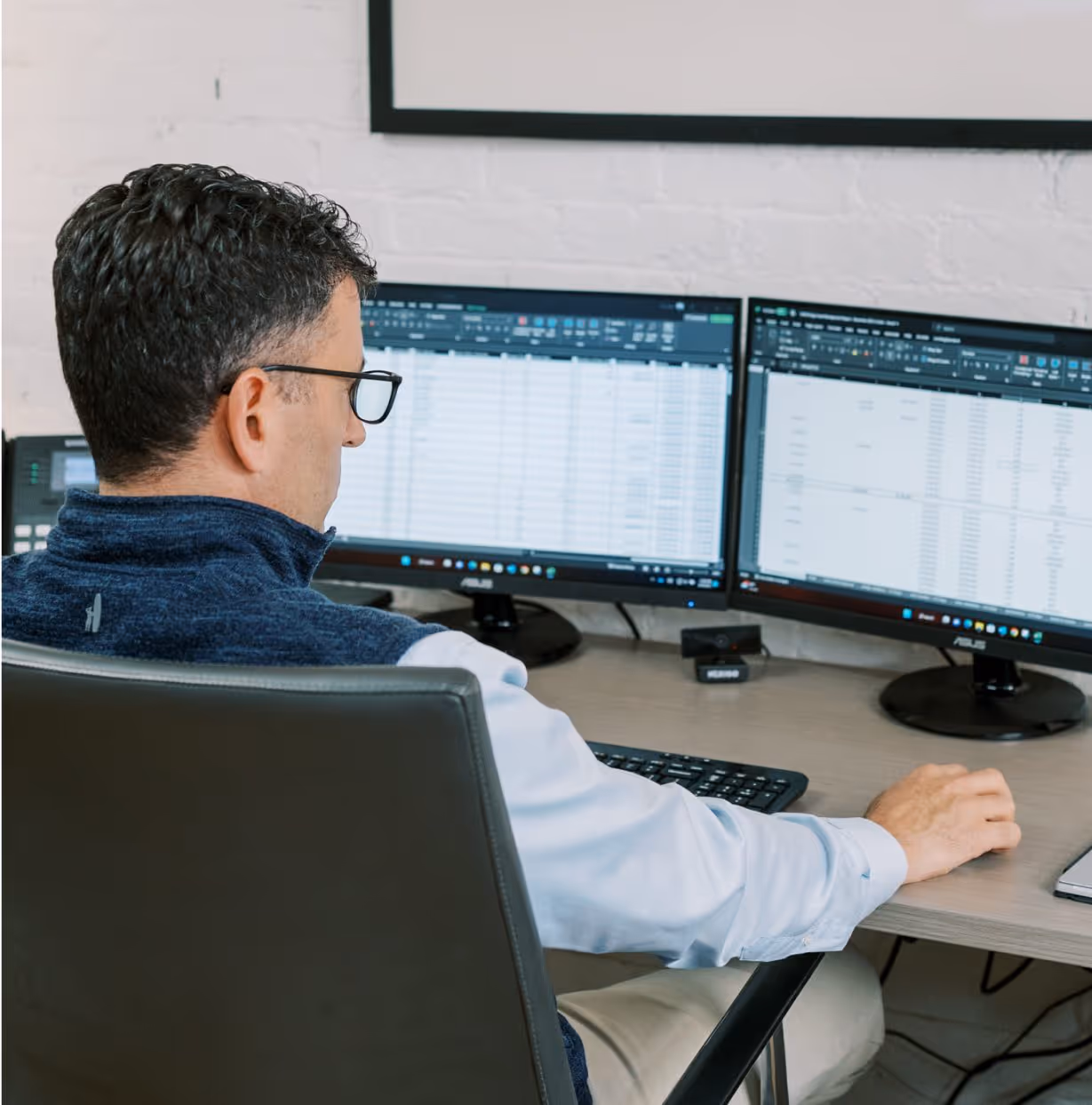 VIUM Capital working at desk, financial