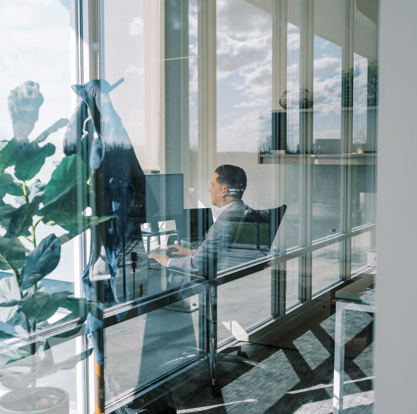 VIUM Capital office interior view, glass walls office, male working