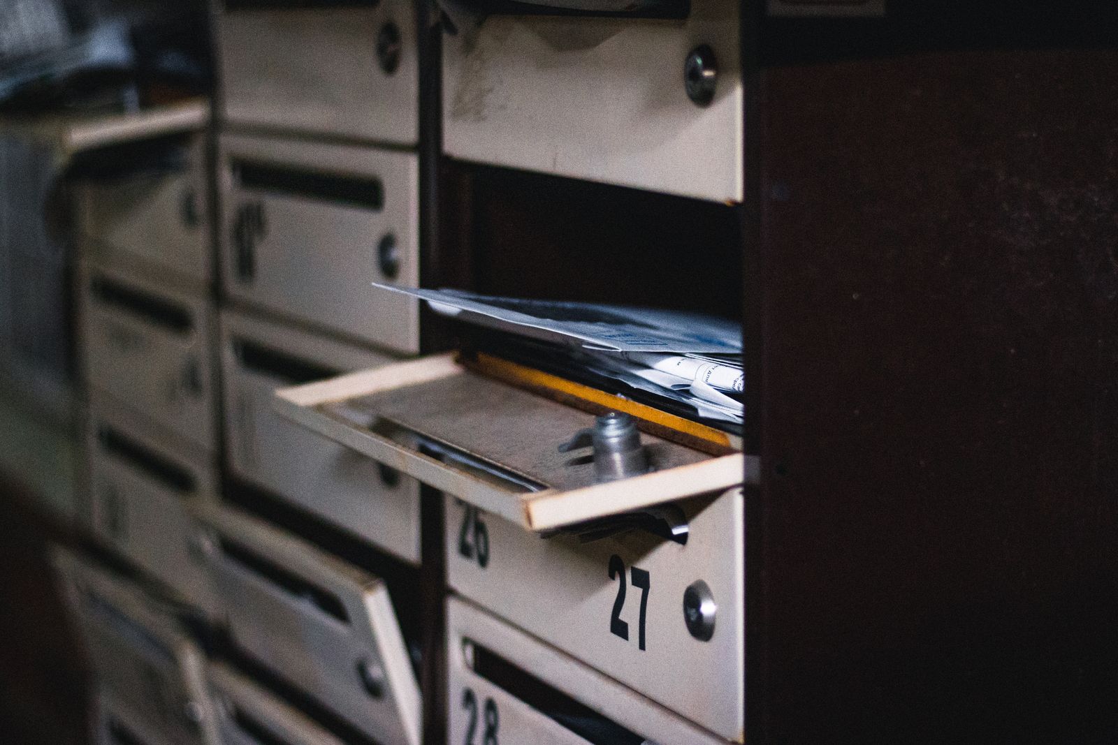 Boîte aux lettres ouverte avec du courrier dans un immeuble résidentiel
