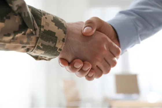 Veteran and businessman shaking hands.