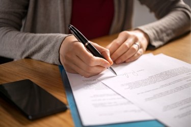 Woman signing legal papers