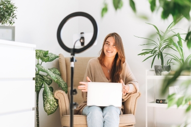 Woman filming herself unboxing