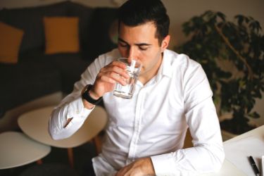 Business man drinking water