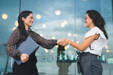 Two women shaking hands