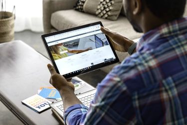 Man with LinkedIn Page in the tablet