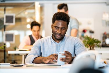 Man checking his phone during work