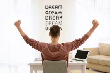 Motivated man lifting his arms