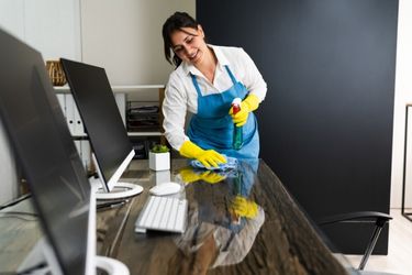 Housekeeper cleaning the office