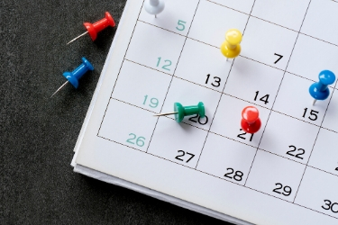 pushpins on a calendar
