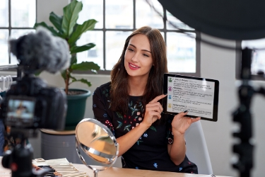 woman pointing at an ipad