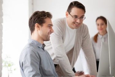 one person teaching another while being supervised