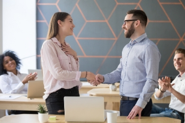 man and woman colleague shaking hands