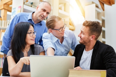 Group of people in front of a computer