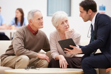 Salesman talking to an elderly couple