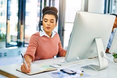 Woman making follow up calls and taking notes