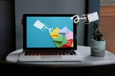 Email marketing concept - sending emails on a laptop