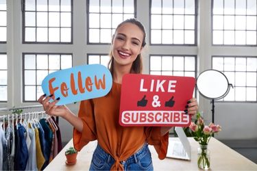 Influencer with the sign "Follow" and "Like & Subscribe"