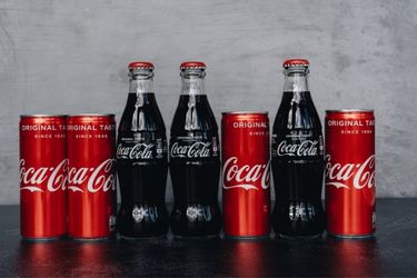 Coca Cola bottles and cans branding with colors and logo