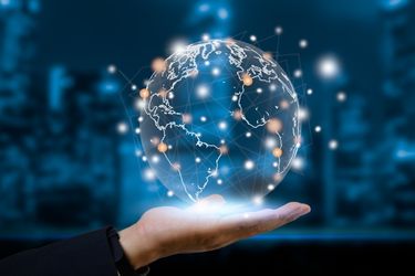 Hand holding a digital world