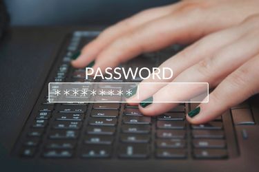 Fingers typing the Password