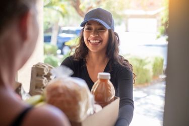 Woman delivering groceries to someone