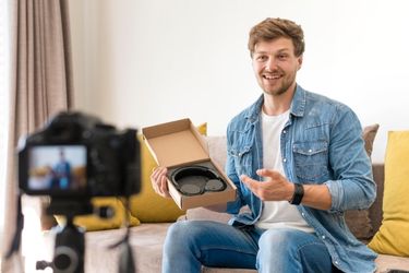 Man unboxing some headphones
