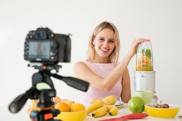 Woman filming herself using a blender