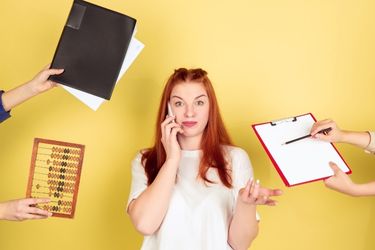 Woman on the phone and people handing her things to do