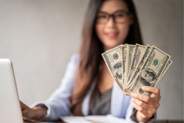 Professional woman holding cash