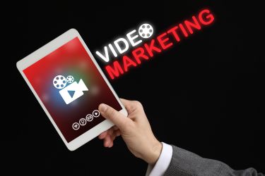 Marketing Strategy - Man holding a tablet and the words "Video Marketing"